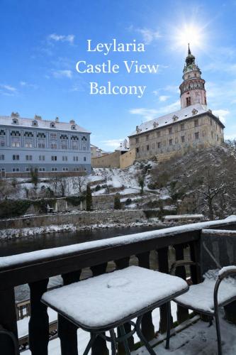a bench sitting on top of a balcony with a building at Leylaria in Český Krumlov