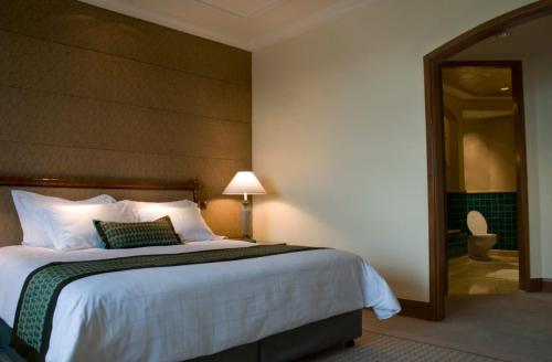 a hotel room with a large bed and a mirror at Sparsh Inn Hotel & Geust House in Gorakhpur