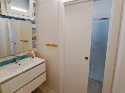 a bathroom with a sink and a shower at Serene Sea - Holiday Homes in Marina di Pescoluse