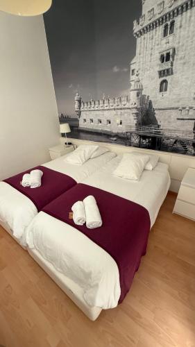 a large bed with white pillows on top of it at Lisboa II Hotel Restaurant in Luxembourg