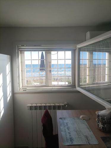 a room with a window with a view of the beach at CASINA SULLa SABBIA in Torvaianica