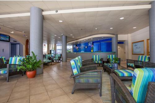 a lobby of a resort with chairs and tables at Aqua Aloha Surf Waikiki in Honolulu