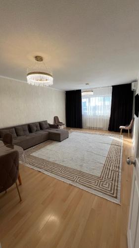 a living room with a couch and a rug at RentHouse Samal in Astana