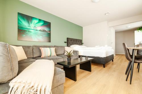 a living room with a couch and a bed at Lofoten Premium Suites in Leknes
