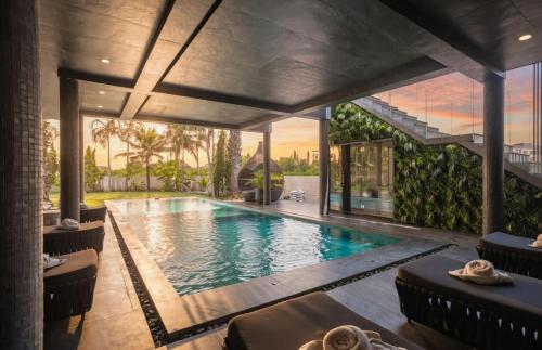 a swimming pool in a house at Palm Villa - Award Winning Modern Luxury & Exclusive Villa in Chiang Mai