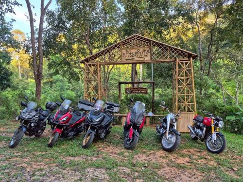 a group of motorcycles parked in front of a basketball hoop at Ban Kham Kee Homestay in Chiang Mai