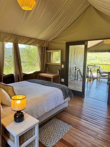 a bedroom with a bed in a tent at Howberry Hills in Plettenberg Bay