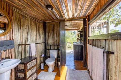 a bathroom with a toilet and a sink at Howberry Hills in Plettenberg Bay