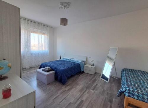 a bedroom with a bed and a mirror in it at Sweet home in Novara