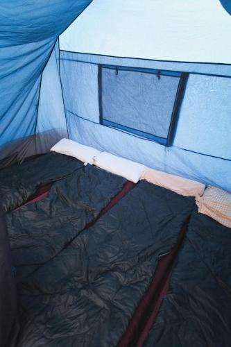 a close up of the inside of a tent at Beer Base-Camp Oktoberfest camping with free welcome beer and traditional dirndl-lederhosen shop in Munich