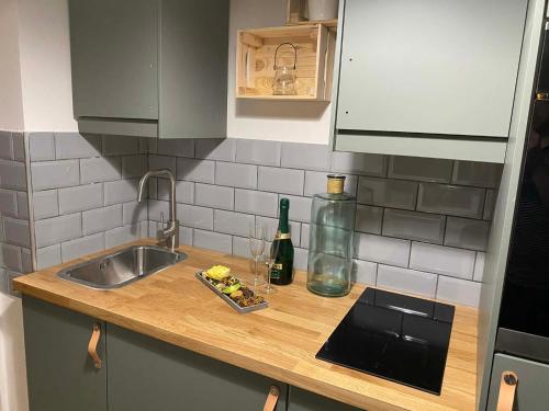 a kitchen counter with a sink and a bottle of wine at Loft2 Apartman X ker in Budapest