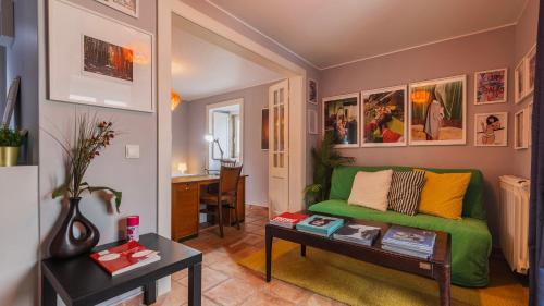 a living room with a green couch and a table at Artsy Sintra I by LovelyStay in Sintra
