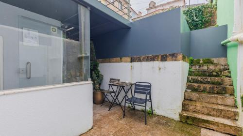 a table and a chair in a room with stairs at Artsy Sintra I by LovelyStay in Sintra