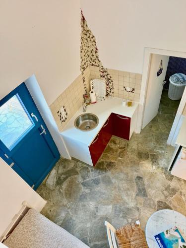 a bathroom with a sink in a room at Peaceful Cycladic Studio with Large Terrace & View in Tripiti
