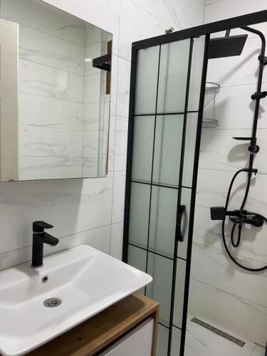 a bathroom with a sink and a shower at 2-Bedroom Flat with a Private Swimming Pool in Bodrum City