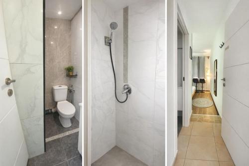 a bathroom with a shower and a toilet at bugrashov 13 room in Tel Aviv