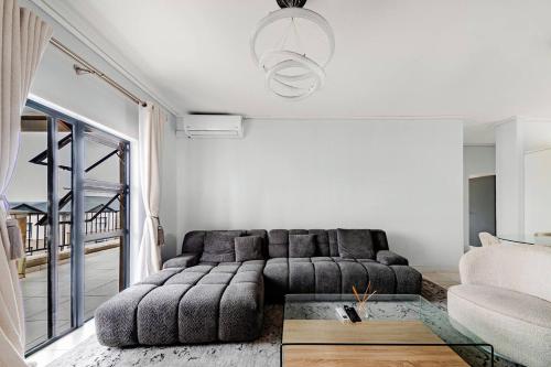 a living room with a couch and a table at 2 Bedroom 2 Bathroom Executive Suite in Midrand