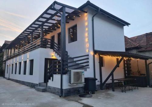 a house with lights on the side of it at URBANIST Guest House in Călimăneşti