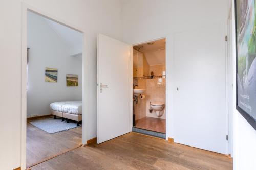 a bathroom with a toilet in a room at Villa Beach & Spa in Julianadorp