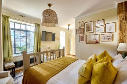 a bedroom with a large bed and a crib at Knoll House in Studland