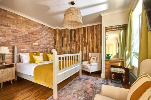a bedroom with a bed and a brick wall at Knoll House in Studland