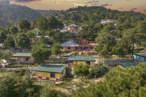 an aerial view of a village with houses and trees at A Kasauli Ggaon by Echor in Kasauli