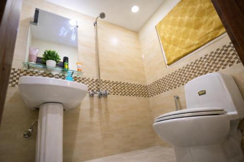 a bathroom with a toilet and a sink at Private 2BD Apartment Opposite Dha Phase 8 in Lahore