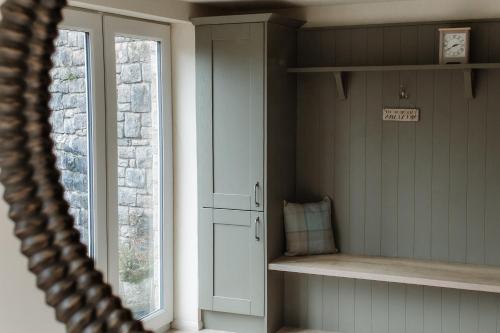 a room with a window and a shelf and a cabinet at Grey Walls in Penrith