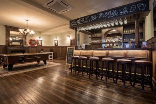 a bar with a pool table and bar stools at Palm Villa - Award Winning Modern Luxury & Exclusive Villa in Chiang Mai