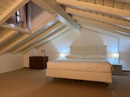 a bedroom with a large bed in an attic at Monza Downtown House Via Bartolomeo Zucchi 5 Monza in Monza
