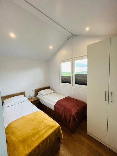 a bedroom with two beds and a window at Słoneczny Pagórek in Giżycko