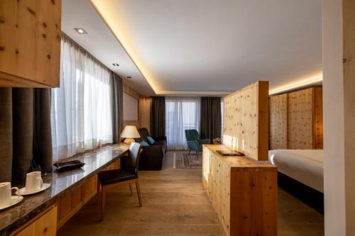 a hotel room with a bed and a living room at Hotel St. Michael in Livigno