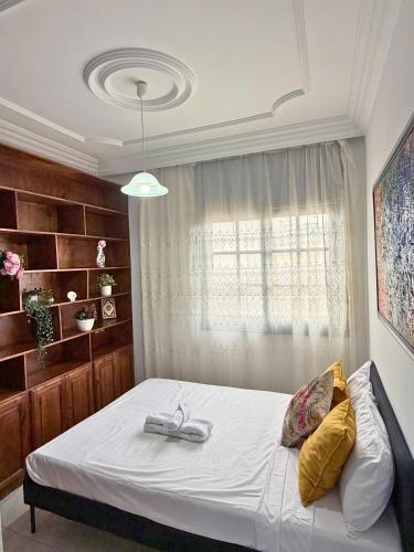 a bedroom with a large bed with a window at 2 chambres tout confort - calme absolue in Temara