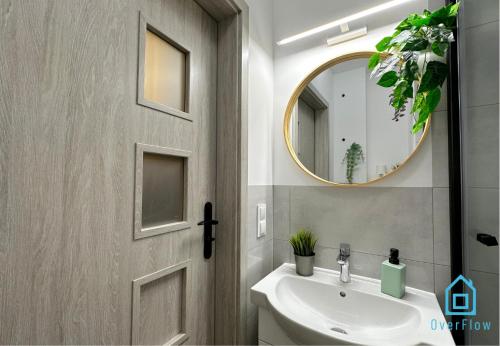 a bathroom with a sink and a mirror at Piggy Room - 3 km to Baltic Sea in Gdańsk
