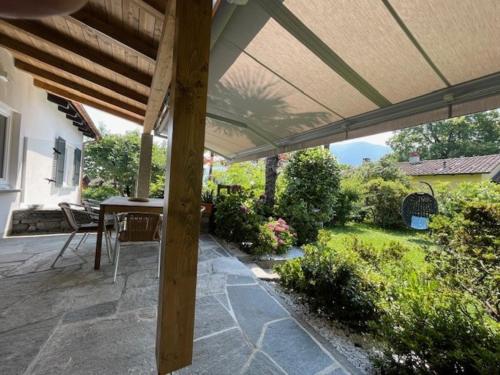 a patio with a table and an umbrella at Ascona Casa Cristina in Ascona