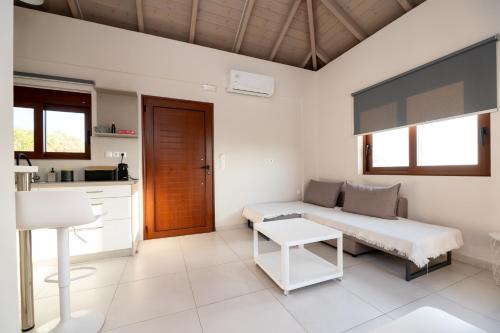 a living room with a couch and a table at Mary's Panorama Houses in Gialova