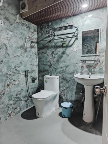 a bathroom with a toilet and a sink at Beyond Baari Inn in Darjeeling