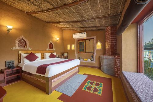 a bedroom with a large bed and a fireplace at A Kasauli Ggaon by Echor in Kasauli