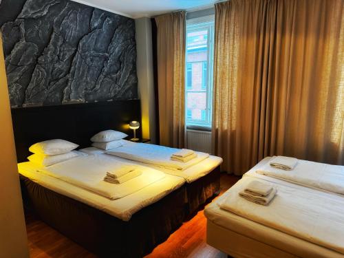 a hotel room with two beds and a window at Hotel Villan in Gothenburg