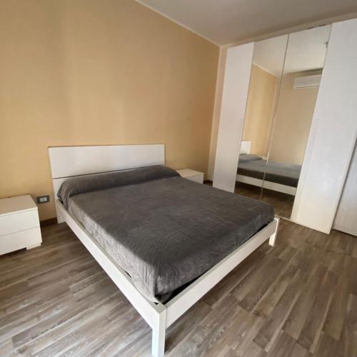 a bedroom with a bed and a mirror at A Casa Di Mina in Civitavecchia