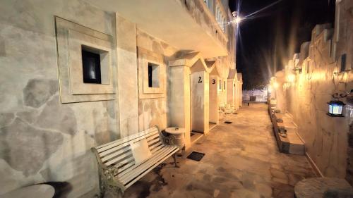 an empty hallway with a bench in a building at Castellino Studios in Faliraki