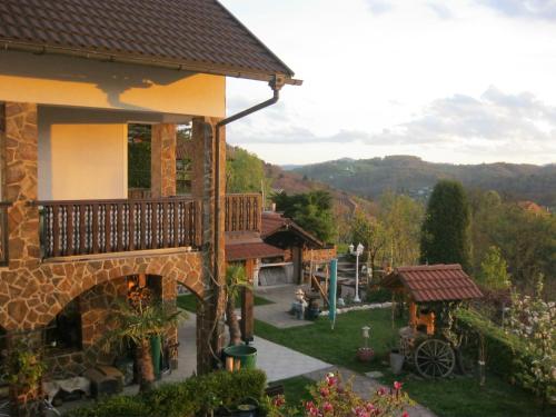 a view of a house with a balcony and a yard at Hiša Koražija in Rogaška Slatina