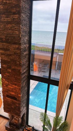 a room with a view of a swimming pool and the ocean at Villa Bella in Atakum