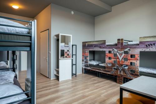 a room with a bunk bed and a brick wall at a&o Copenhagen Nørrebro in Copenhagen