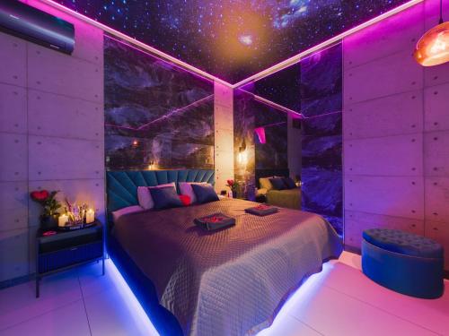 a bedroom with a bed with a star ceiling at LoveAparts Marki Romantic Stay in Marki