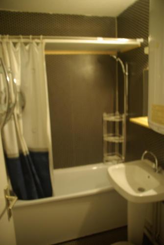 a bathroom with a tub and a sink and a shower at appart st gervais le Topaze in Saint-Gervais-les-Bains