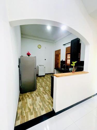 a kitchen with a stainless steel refrigerator in a room at Lotus villa in Matara