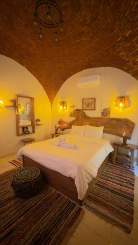 a bedroom with a large bed in a room at King Sahure Pyramid Inn in Cairo
