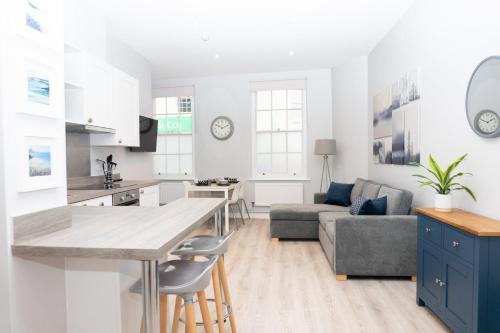 a kitchen and living room with a couch and a table at Spa Court in Cheltenham