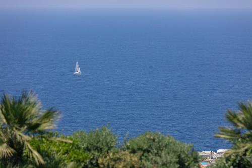 a sail boat in the water with acean at Villa Dei Sogni, for the Design Lovers,By ThinkVilla in Agia Pelagia